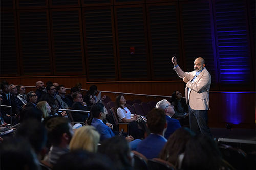 Dr. Karim Lakhani speaking in front of an audience