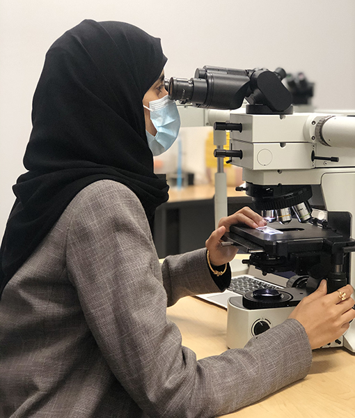 student at microscope
