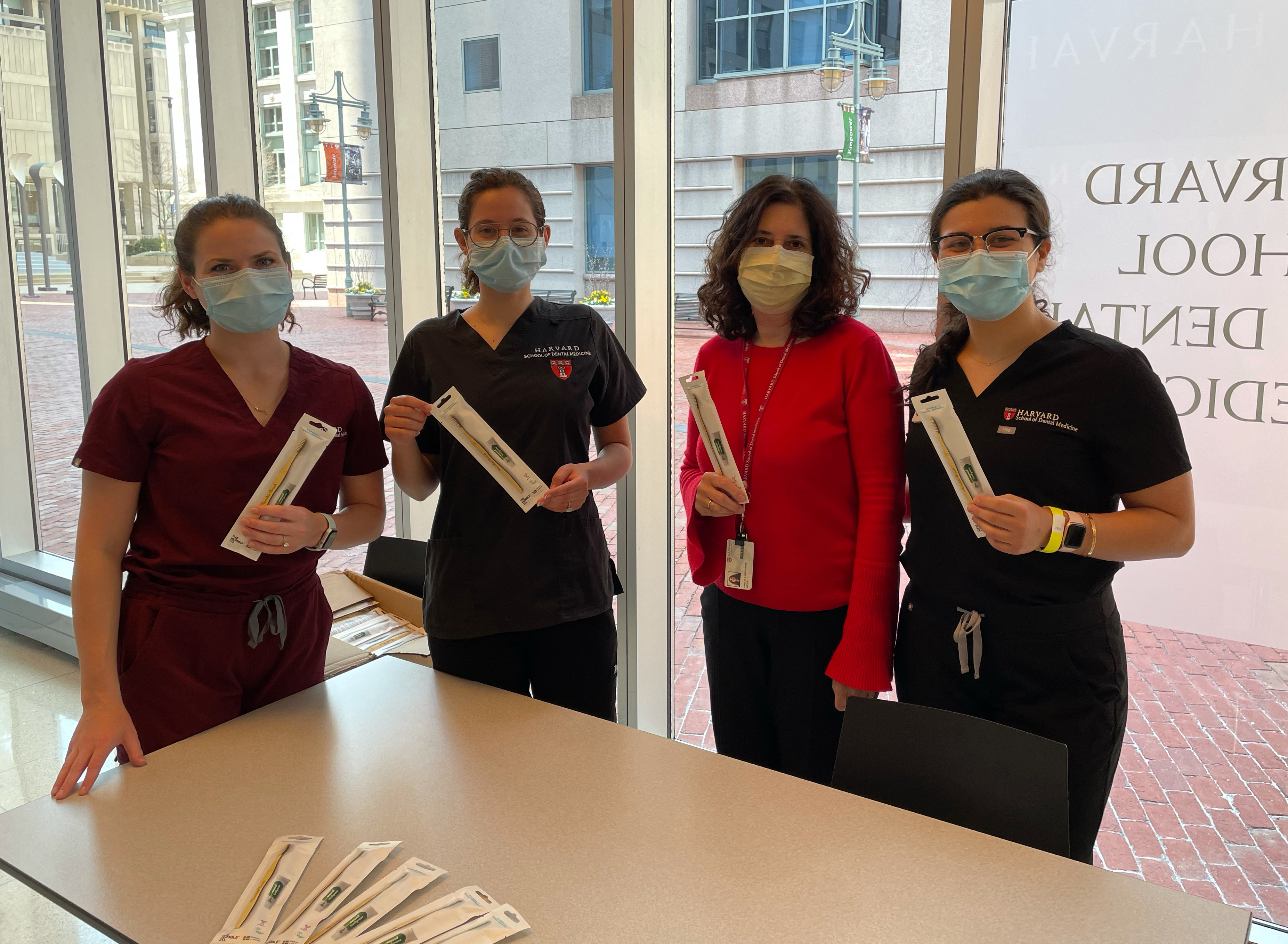 Members of the Green Team and Sustainability Committee handing out bamboo toothbrushes to students and faculty.