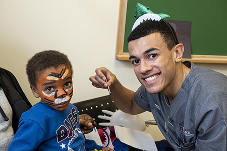 child having face painted