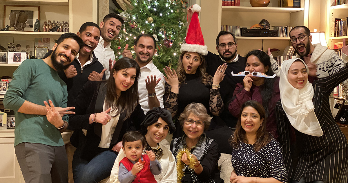 Kobie Gordon, MMSc21, poses with fellow dental public health residents in front of a Christmas tree