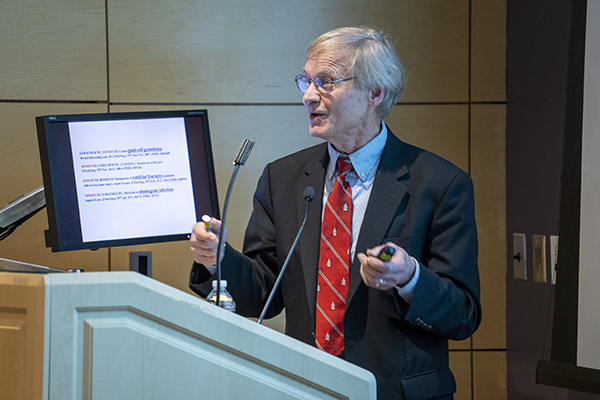 Dr. Olsen at a podium presenting his research