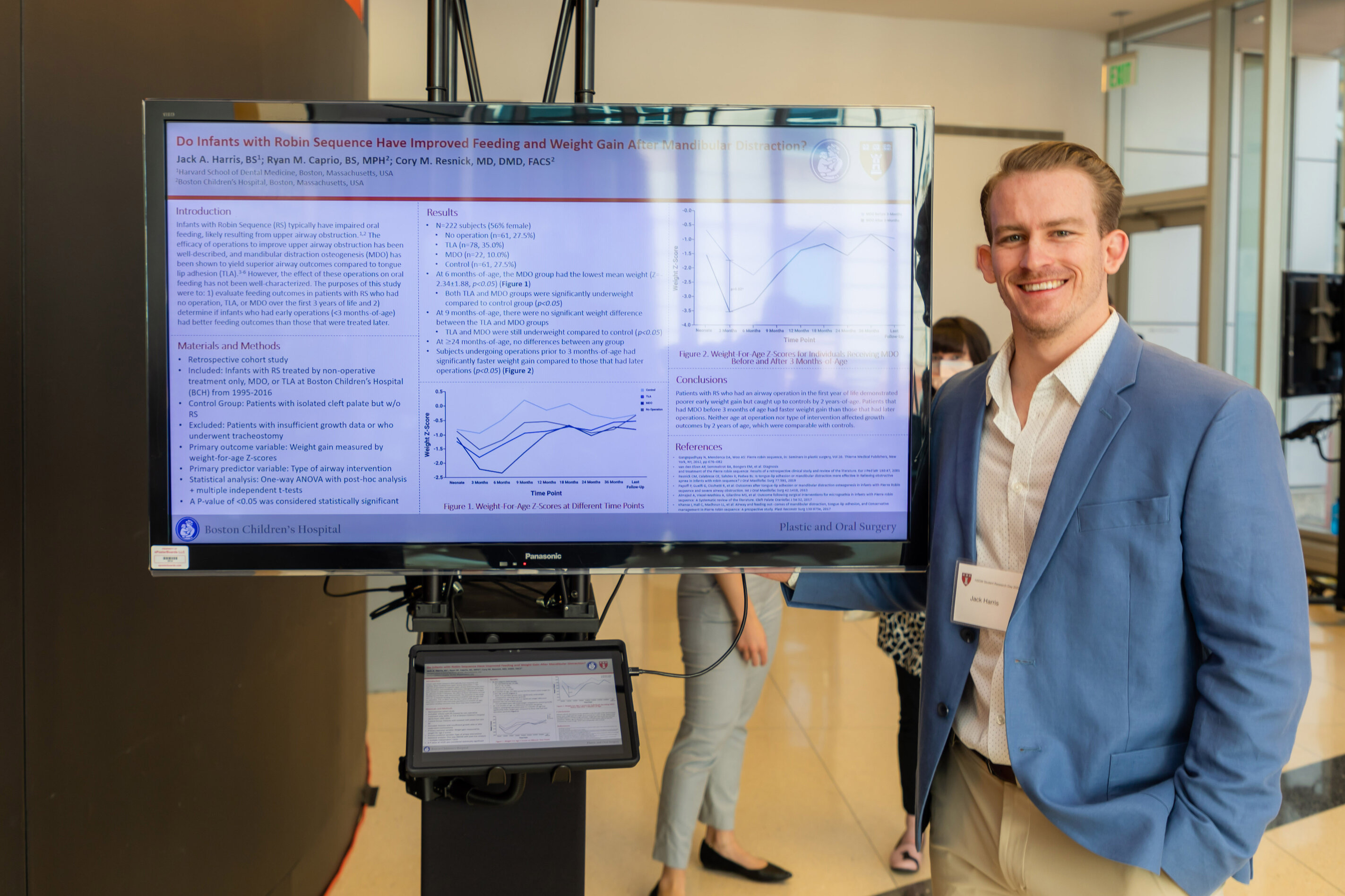 Student standing next to digital screening