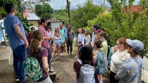 Group of Students listening to a speaker in the rain forrest of Costa Rica.