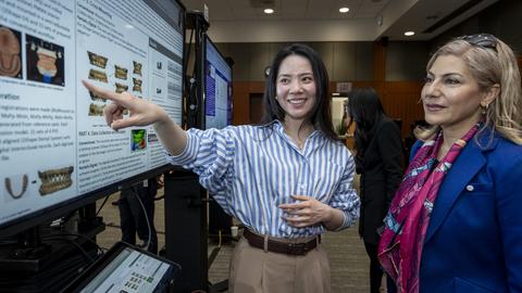 Person pointing to a poster