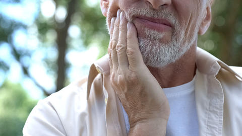 A person holding their jaw