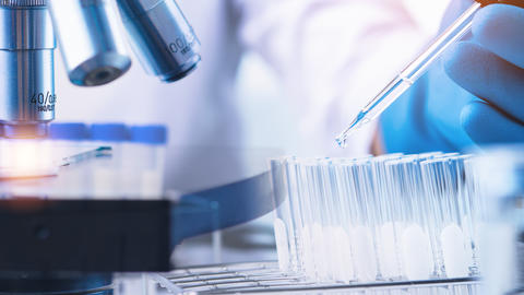 Scientist with equipment and science experiments ,laboratory glassware containing chemical liquid