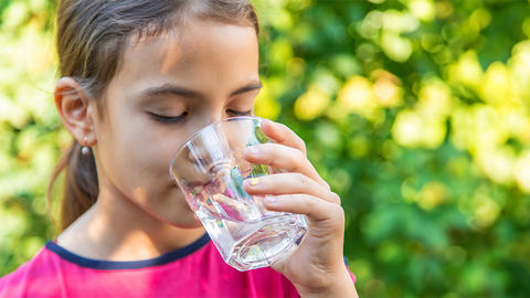 girl drinking a glass of water