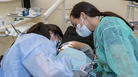 students working on a patient
