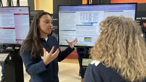 Student presenting research to another individual
