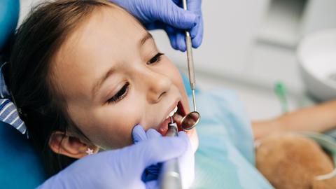 child having teeth examined