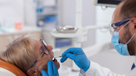 senior having teeth examined 
