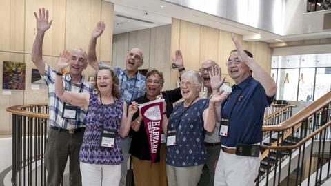 Class of 81 with their hands in the air