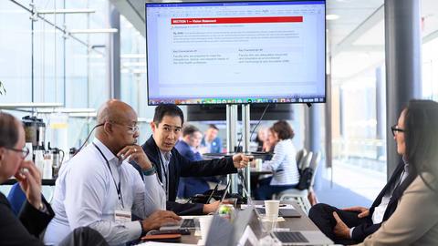 working group in front of a screen