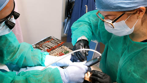 clinicians working on a patient