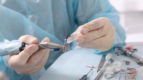 Dental implant in the hands of a surgeon. 