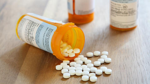 Rx bottle with pills spilling out