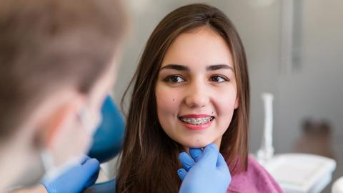 Orthodontic patient with braces during a dental examination.