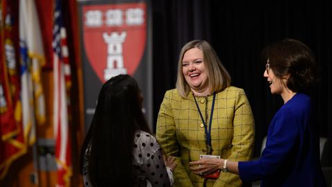 3 women in conversation with HSDM in background