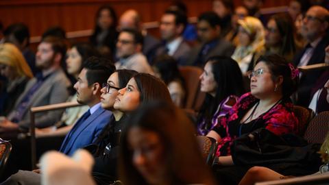 audience in a darkened auditorium