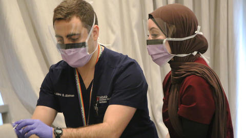 Two dentists looking at a patients mouth