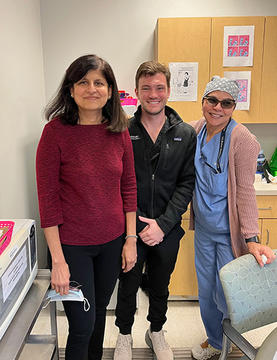 Bart flanked by colleagues at his externship site