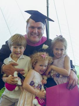 Graduate with his three kids