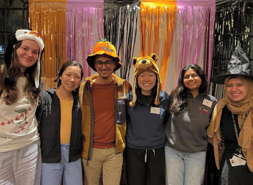 Residents in costume pose together during a Halloween community celebration at Vanderbilt Hall.