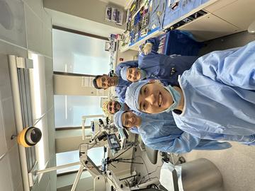 group of students in PPE posing for a selfie in the clinic