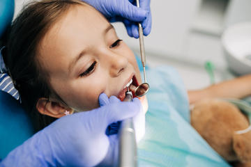 child having teeth examined