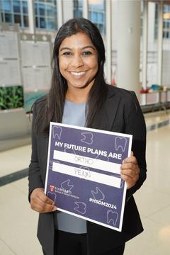 A student holding a blue sign