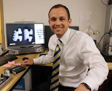 Dr. Alfred Griffin sitting in front of a computer