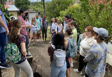 students listening to speaker in the field