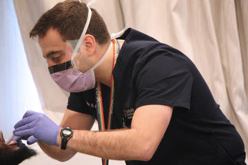 Dentist looking at a patients mouth