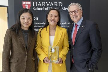 Janice Lee holding an award