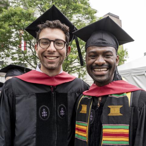 Two graduates smiling