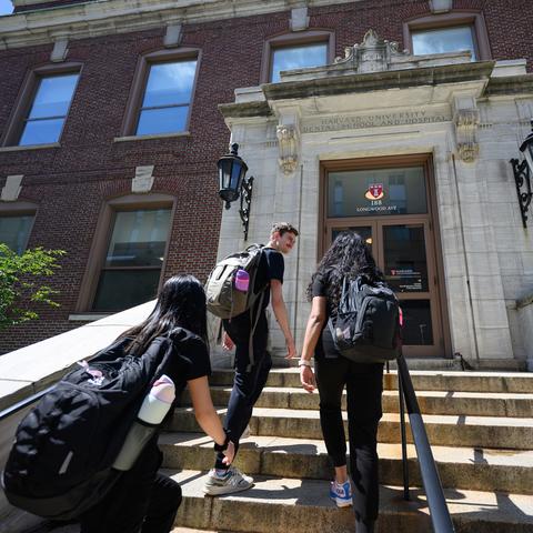 Students walking up front steps of HSDM