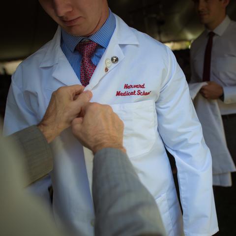 Person putting on white coat