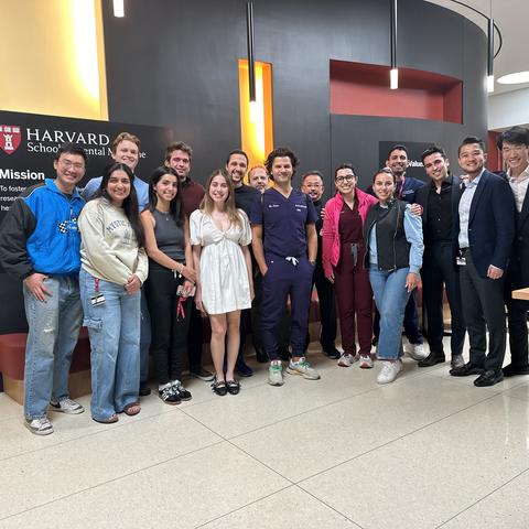 A large group of students standing in the lobby of HSDM