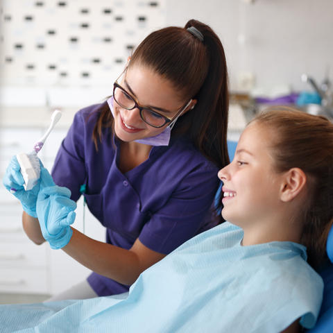 dentist showing a dental impression to a child 
