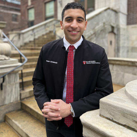 Student standing on steps of main building