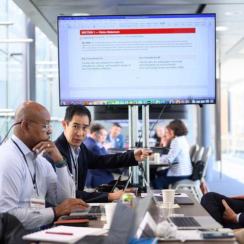 working group in front of a screen