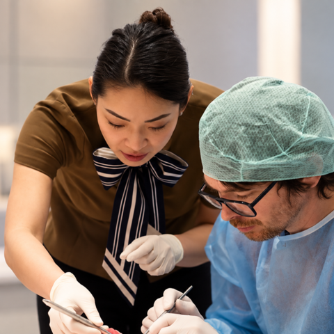 female clinician instructing male student