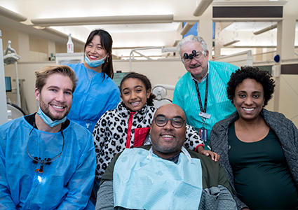 vet surrounded by family and students