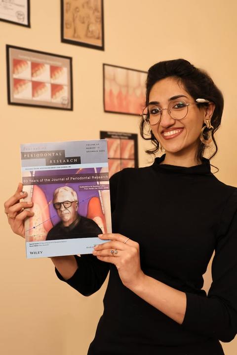 Zayyad holding a magazine cover she illustrated