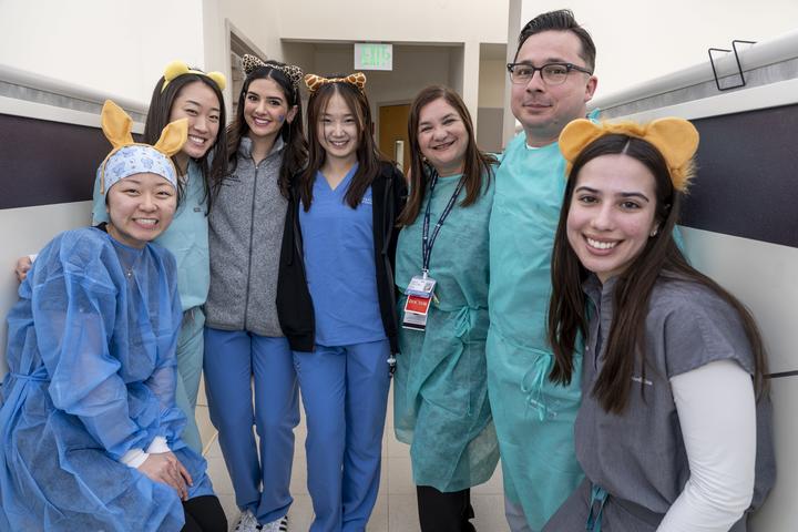 A group of students in PPE and animal ear headbands