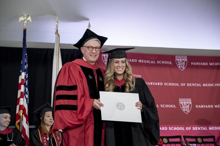 Middleton holding her degree next to Dean Giannobile