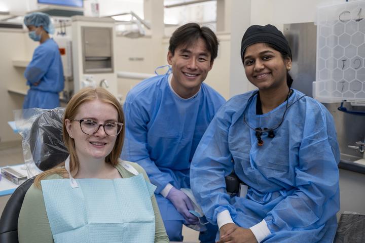 Dental students and a patient in a clinical training setting