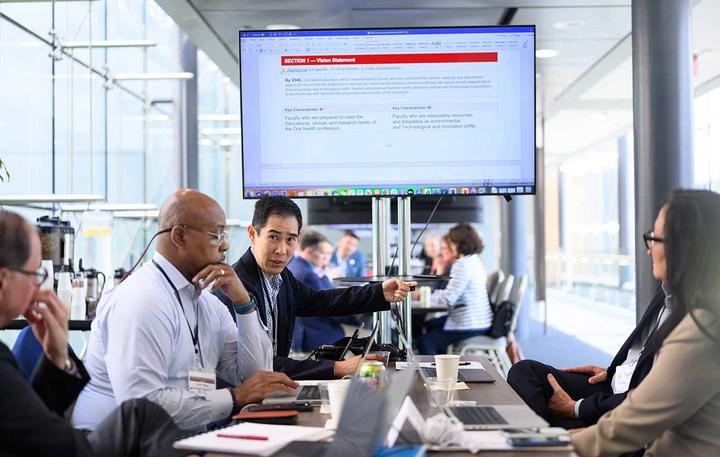 working group in front of a screen