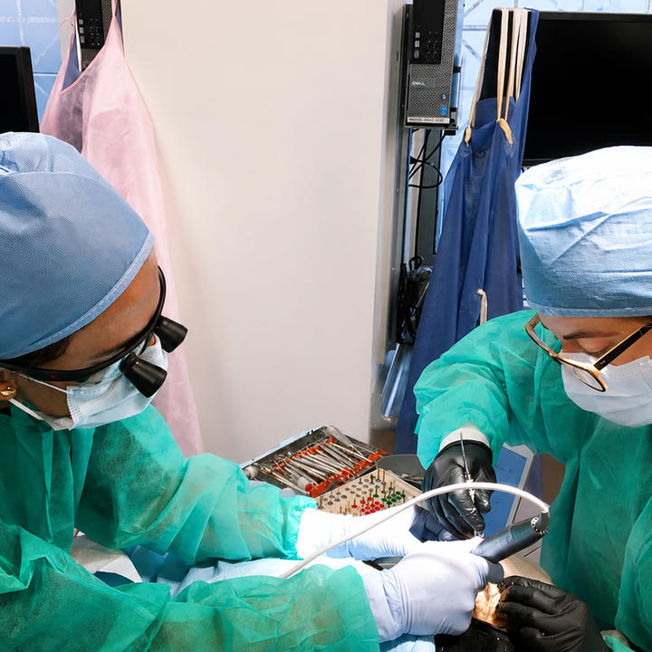 two clinians working on a patient.